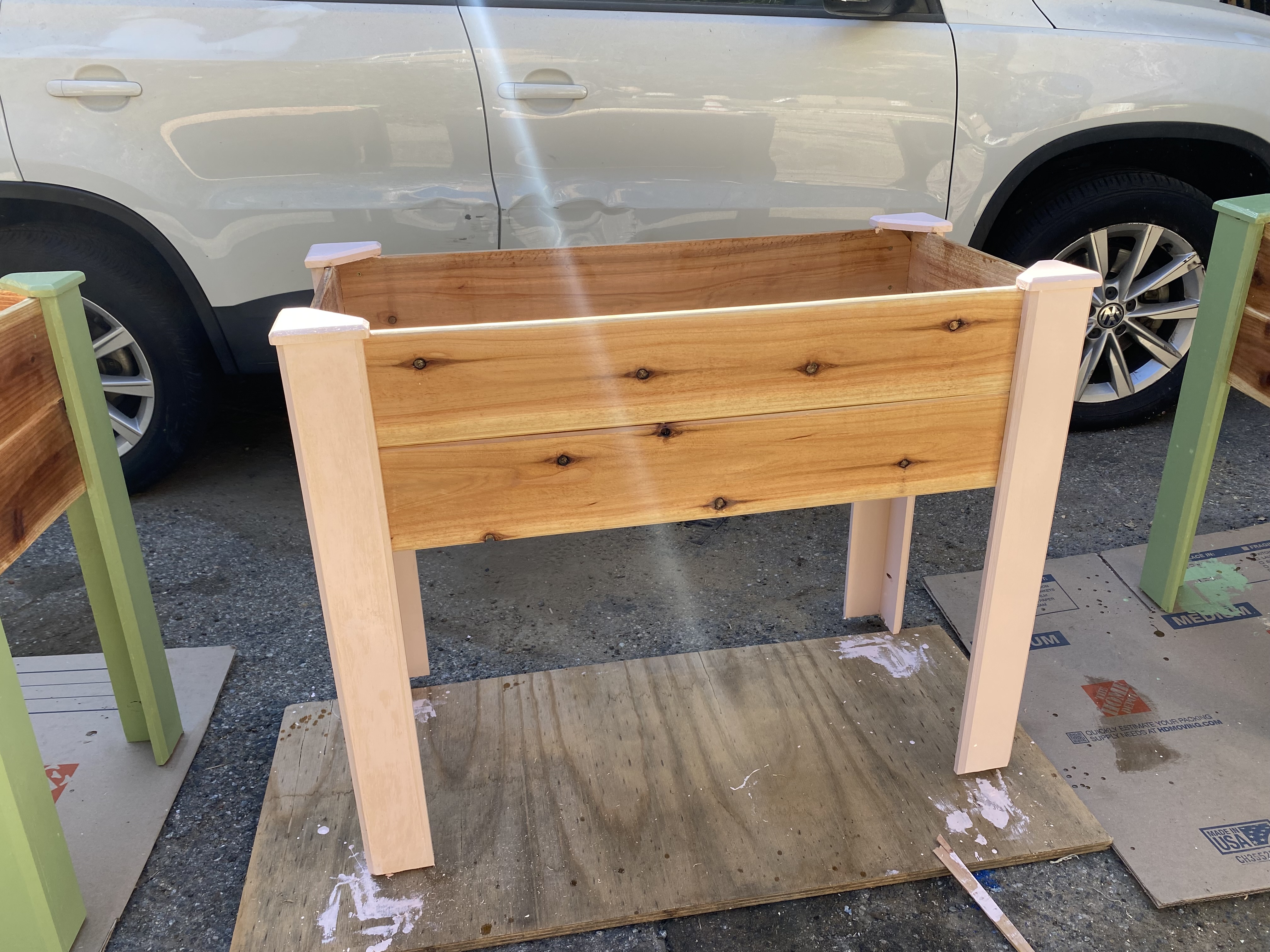 Raised planter box with pink painted legs