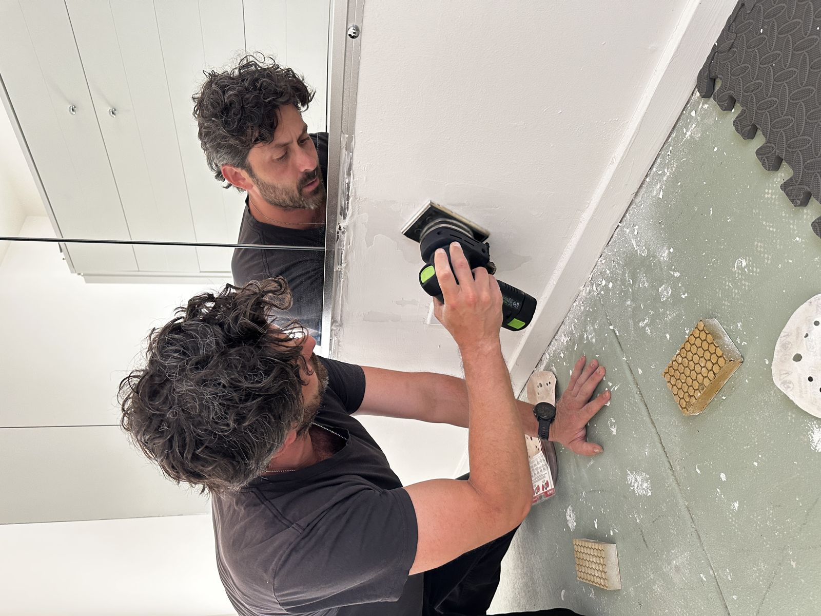 Jason from The Dad Squad sanding drywall